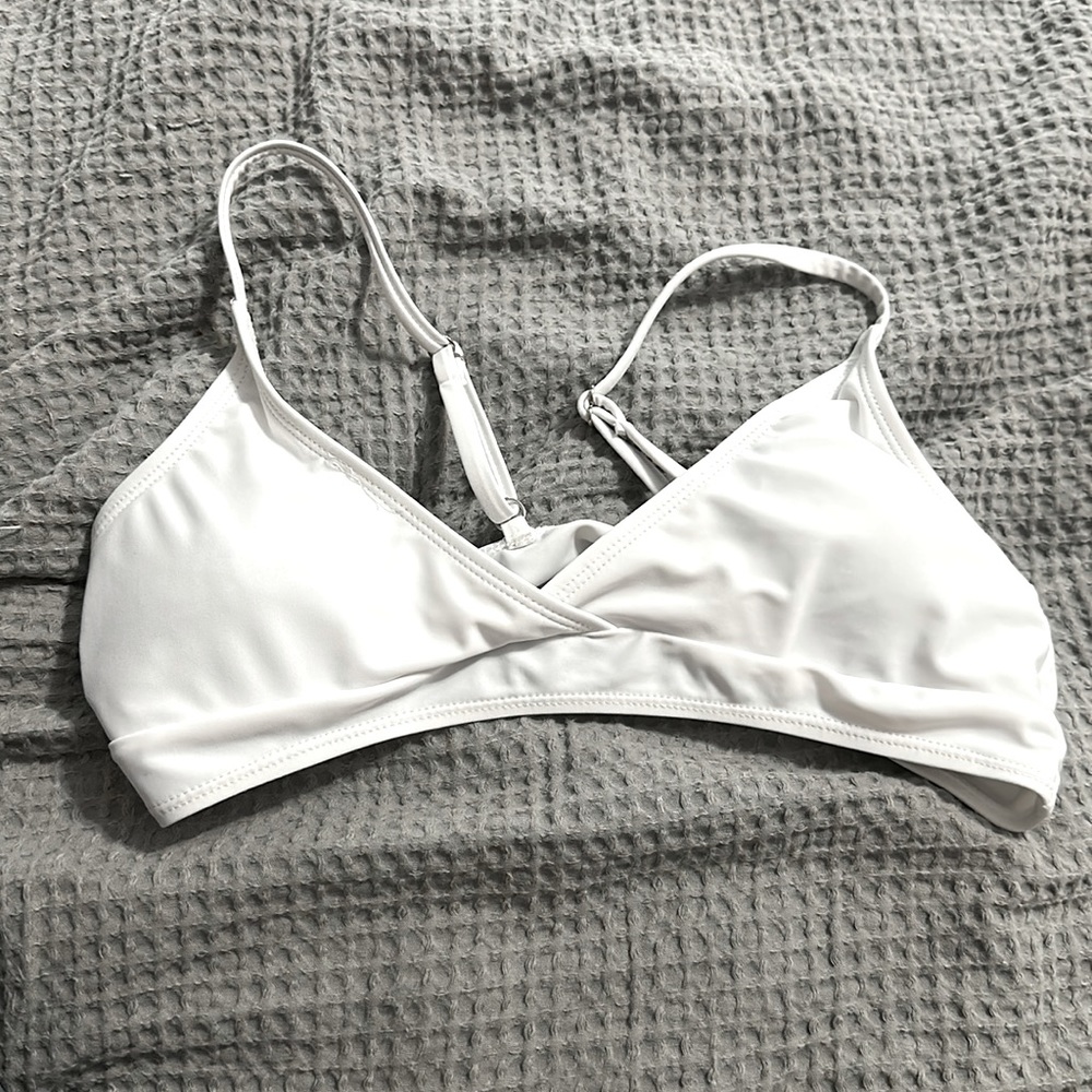 A small white top that is very cute but small
